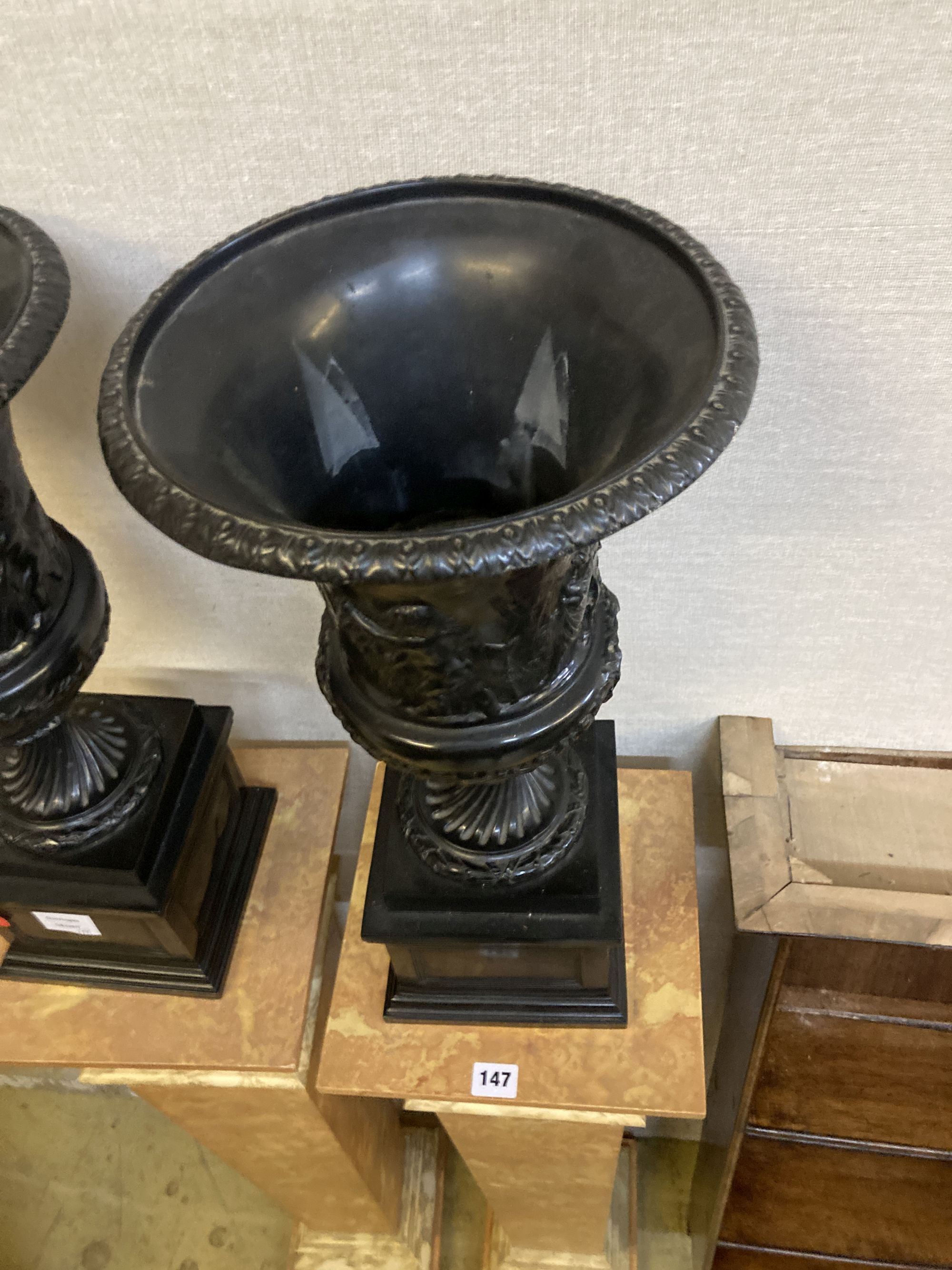 A pair of reproduction neoclassical composition pedestals and campana shaped urns, height 164cm